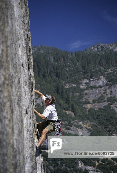 Solo male rock climbing in Yosemite National Park in the Sierra Nevada Range.