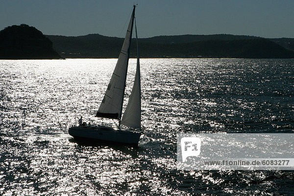 Aerial view of a sailing yacht cruising in Pittwater on the North Shore from Sydney  Australia.