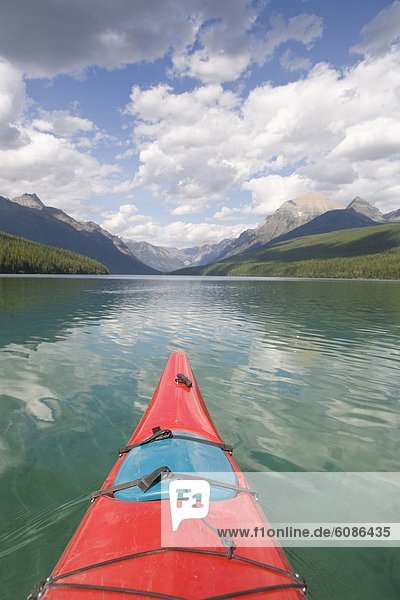 View from a sea kayak on a remote lake in the Rocky Mountains in Glacier National Park.