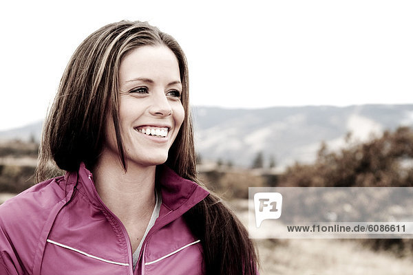 A female smiles while out hiking in the Columbia River Gorge  Oregon.