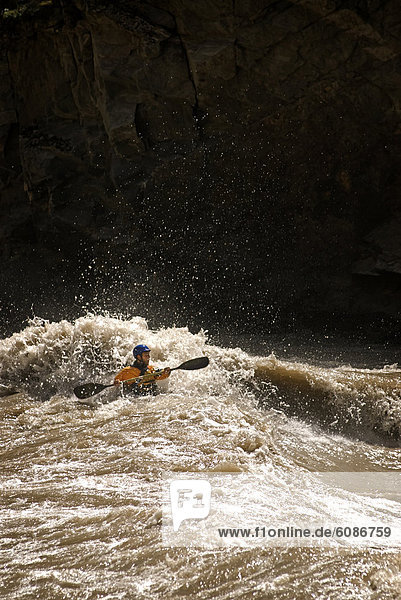 A kayaker encounters big whitewater during a rafting trip in Western China.