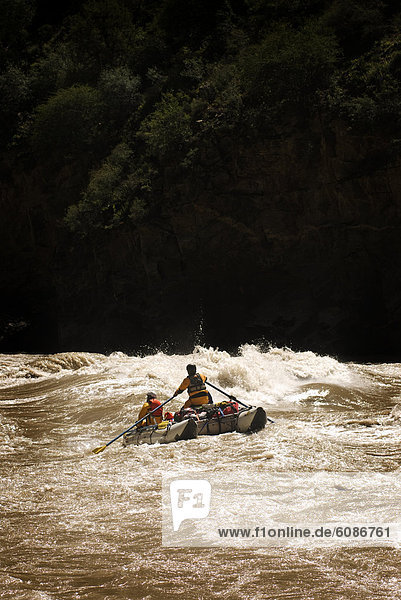 Rubber raft running rapids during a whitewater rafting trip to Western China.