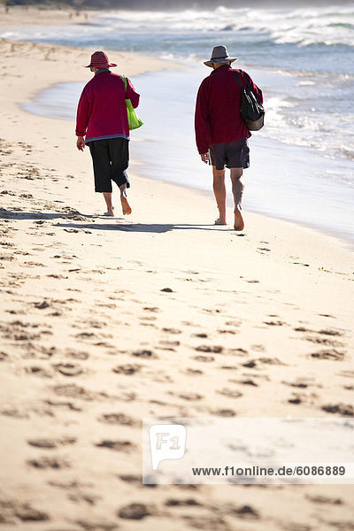 An elderly couple walking at Sunshine Beach  Queensland  Australia.
