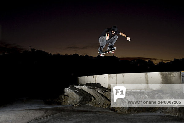 A skater performs a large air jump in Clovelly  New South Wales  Australia.