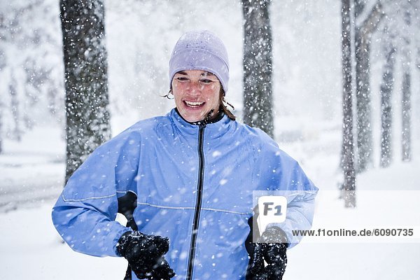 A women runs down Mountain Avenue in a snowstorm.