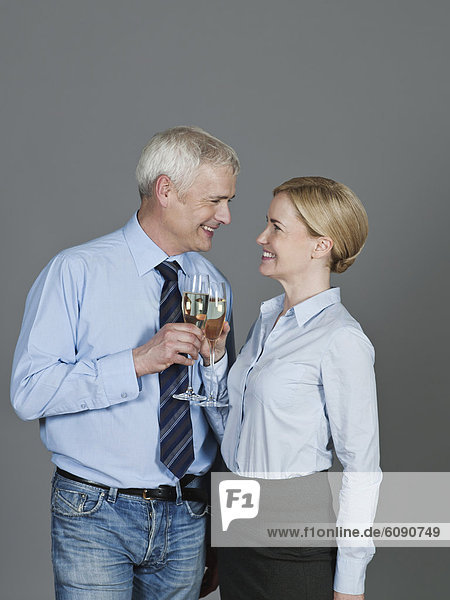 Mature couple drinking sparkling wine  smiling