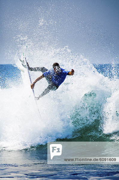 A progressive surfer catching air.