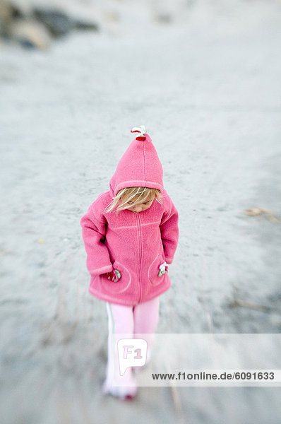 A young girl in pink stays warm.