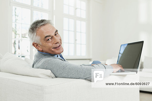 Senior man using laptop  portrait