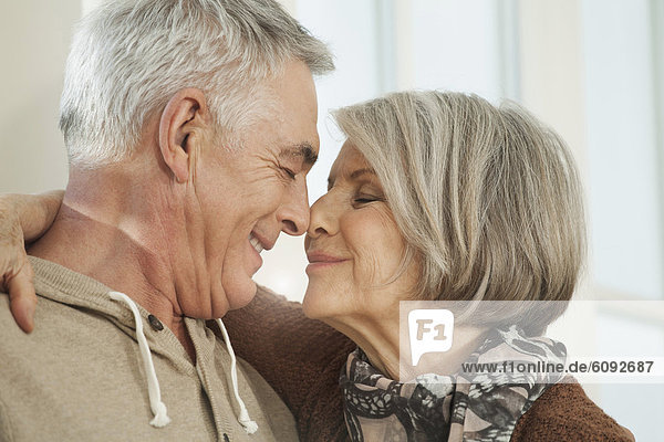 Germany  Berlin  Senior couple rubbing noses  smiling