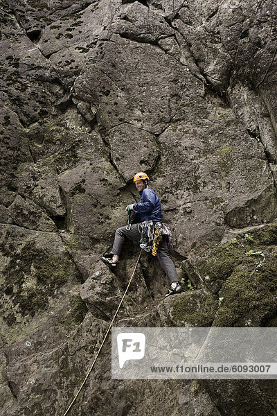 A lead climber pauses while climbing.