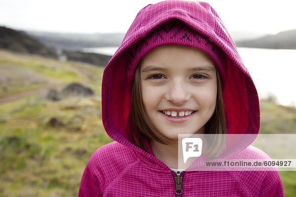 Portrait of a young girl dressed in pink  while out hiking.