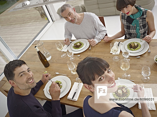 Men and women having dinner