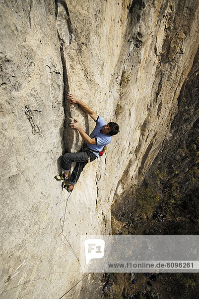 A rock climber ascends a steep rock face in Mexico.