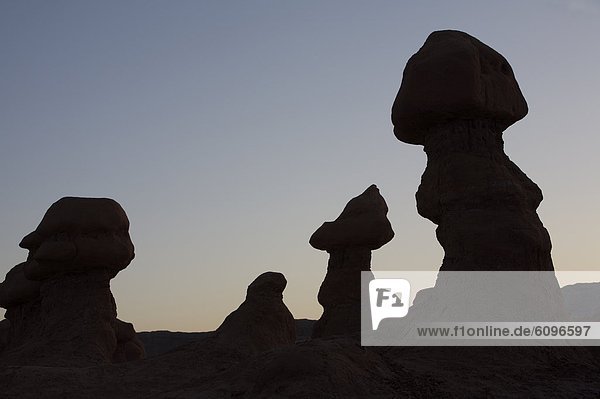 Hoodoos are individual  small rock formations  silhouetting the sky in Goblin Valley State Park  Utah.
