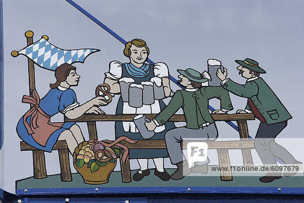 Germany  Bavaria  Munich  Beer garden scene on guild symbol of may pole