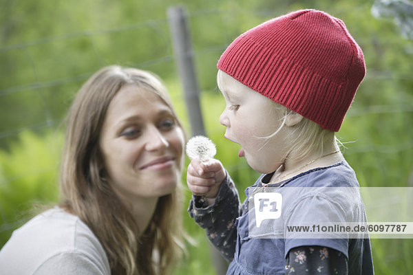 Germany  Bavaria  Mother and daughter with dandelion