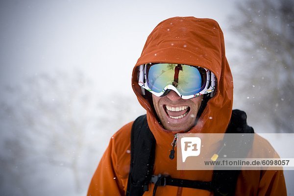 A man is all smiles in the middle of a great day of skiing in Niseko  Japan