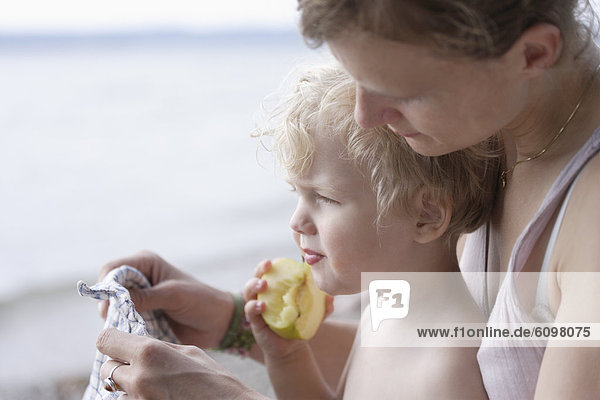 Mother with boy eating apple