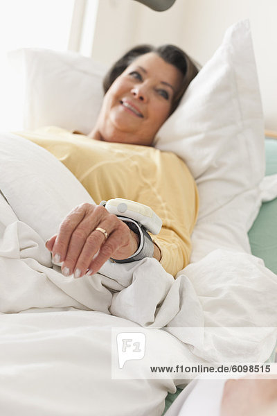 Senior woman lying on medical bed  smiling