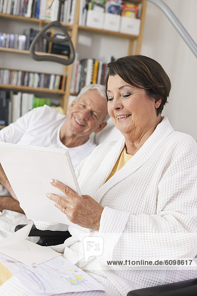 Senior man and woman reading paper