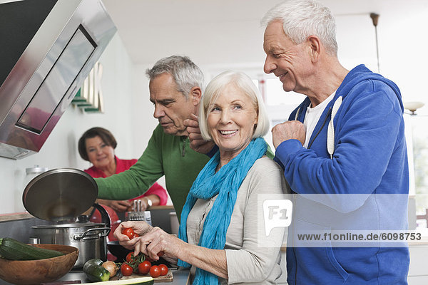 Senior men and women cooking food