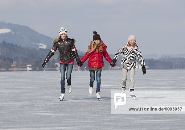 Austria  Teenage girls doing ice skating