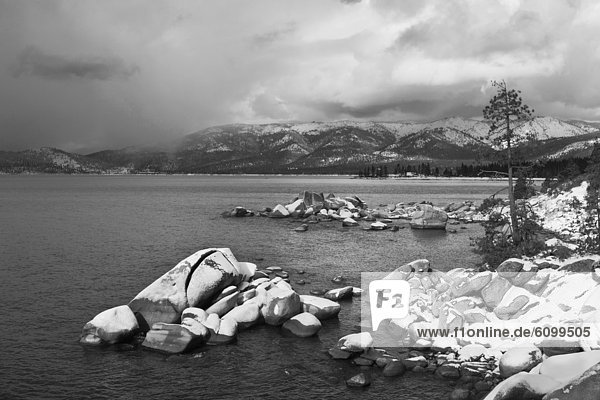 Whale Rock covered in snow and storm clouds on the East Shore of Lake Tahoe in winter in Nevada