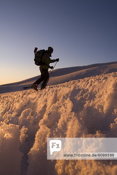 A man skiing through penitentes at sunset on Volcan San Jose in the Andes mountains of Chile