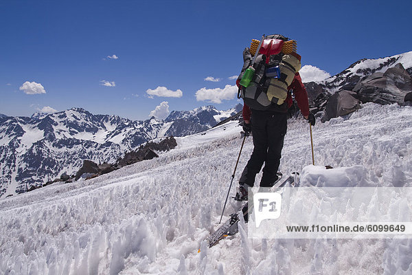 A man ski mountaineering through penitentes on Volcan San Jose in the Andes mountains of Chile