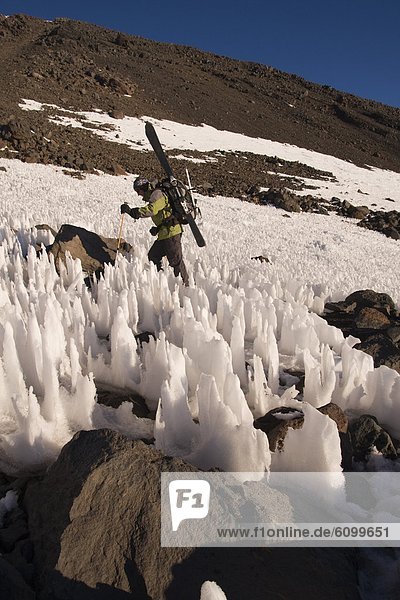 A man ski mountaineering through penitentes on Volcan San Jose in the Andes mountains of Chile