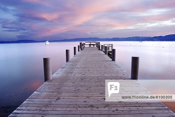 A pier at sunrise on the west shore of Lake Tahoe  California.