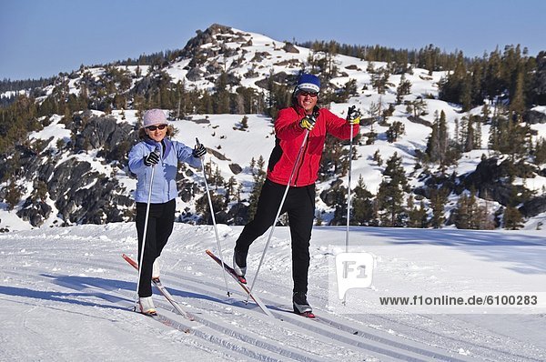 A man and woman cross country ski at Kirkwood Mountain Resort  California.