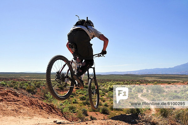 A mountain biker catches some air on the JEM trail in southern Utah.