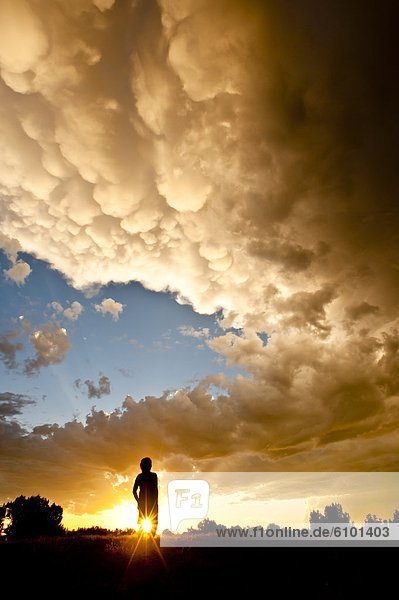 A person standing under an amazing cloud formation. La Junta  Colorado.