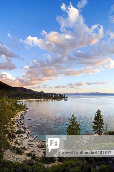 Beautiful clouds are illuminated at sunset over Sand Harbor and Lake Tahoe  Nevada.