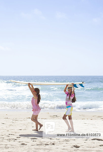 Two young girls walking on the sand in Torrance Beach in Los Angeles  California.