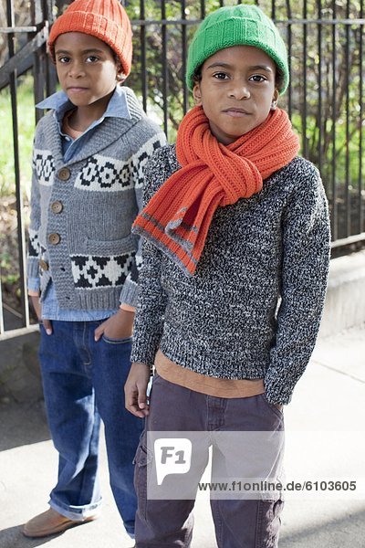 Young twin boys posing for a portrait in Harlem  New York.