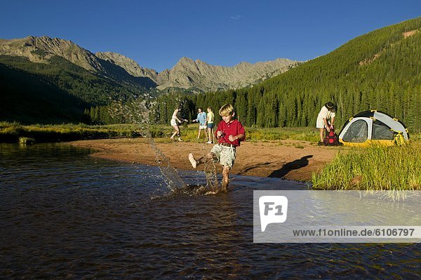 A family camping at an alpine lake.