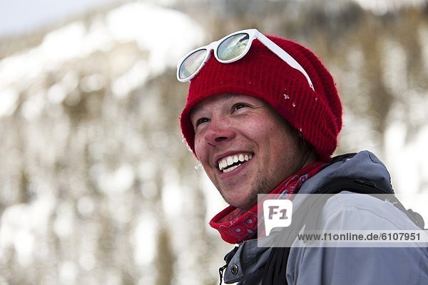 A happy skier smiling in the backcountry in Montana.