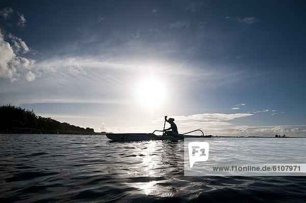 Woman paddling an open ocean canoe  Rarotonga  Cook Islands