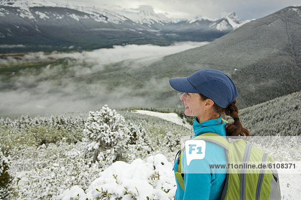 A woman looks out over Kananaskis Country  Alberta  Canada.