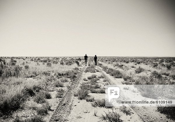 Two tourists stand in the desert near Cuba New Mexico