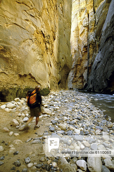 A hiker in a narrow canyon in Utah  USA.