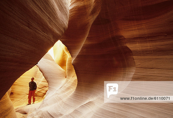 A hiker in a slot canyon in Utah  USA.