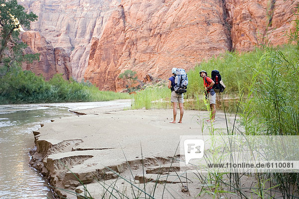 Two hikers in a canyon in Utah  USA.