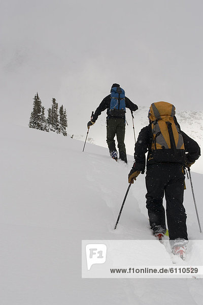 Two adults ski-tour in mountains