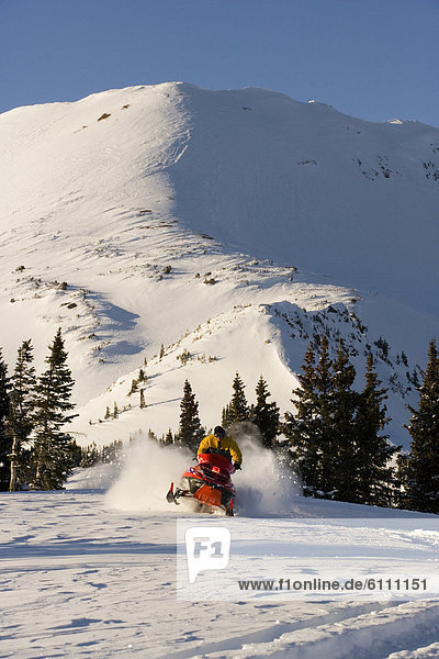 Snowmobiling in the mountains.