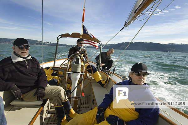 A group of men on a sailing yacht.
