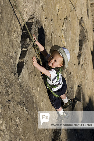 Child top rock climbing.